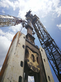 Low angle view of crane against sky