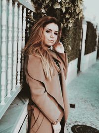 Portrait of beautiful young woman standing outdoors