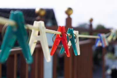 Close-up of clothespins hanging on clothesline