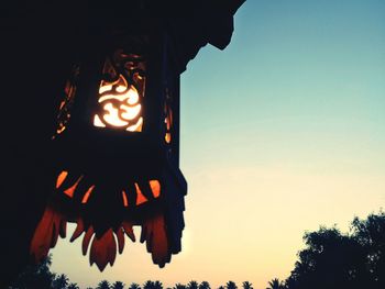 Low angle view of lanterns hanging against clear sky