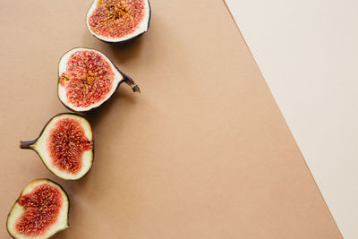 Sliced ripe figs on earthy brown, beige background. food photo background. flat lay. copy space.