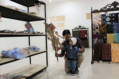 Portrait of young woman standing against wall