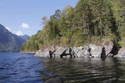 Scenic view of rocks in sea against sky