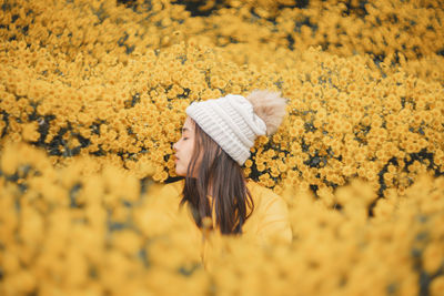 Cropped hand holding yellow flower