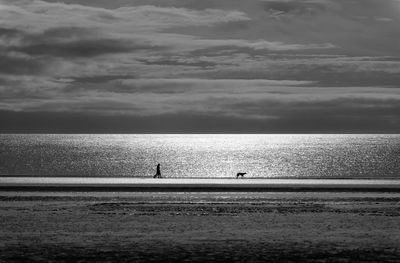 Scenic view of sea against cloudy sky