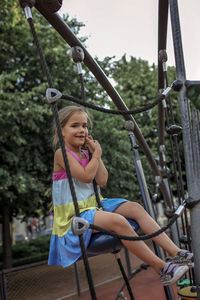 Portrait of smiling girl on playing equipment