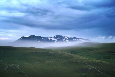 Scenic view of snowcapped mountains against sky