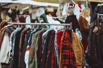 Clothes hanging on rack at market