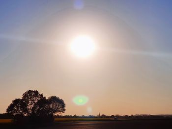 Scenic view of field against sky on sunny day