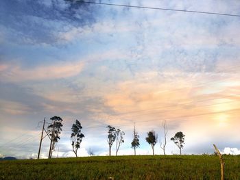 Scenic view of field against cloudy sky