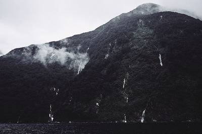 Sea against waterfalls on mountain sea at te anau