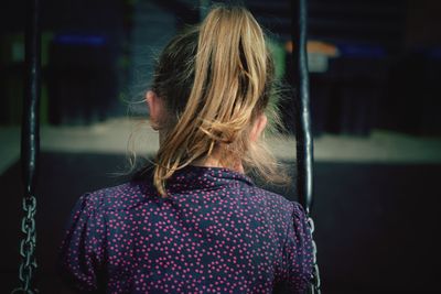 Rear view of girl on swing