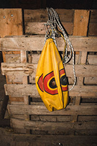 Close-up of yellow representation hanging on wall
