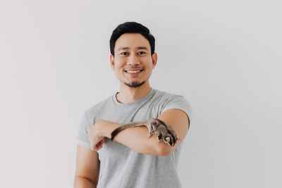 Portrait of young woman gesturing against white background