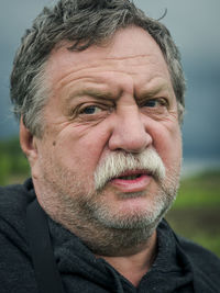 Close-up portrait of serious senior man