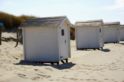 Lifeguard hut on beach against sky