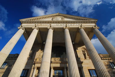 Low angle view of historical building against cloudy sky