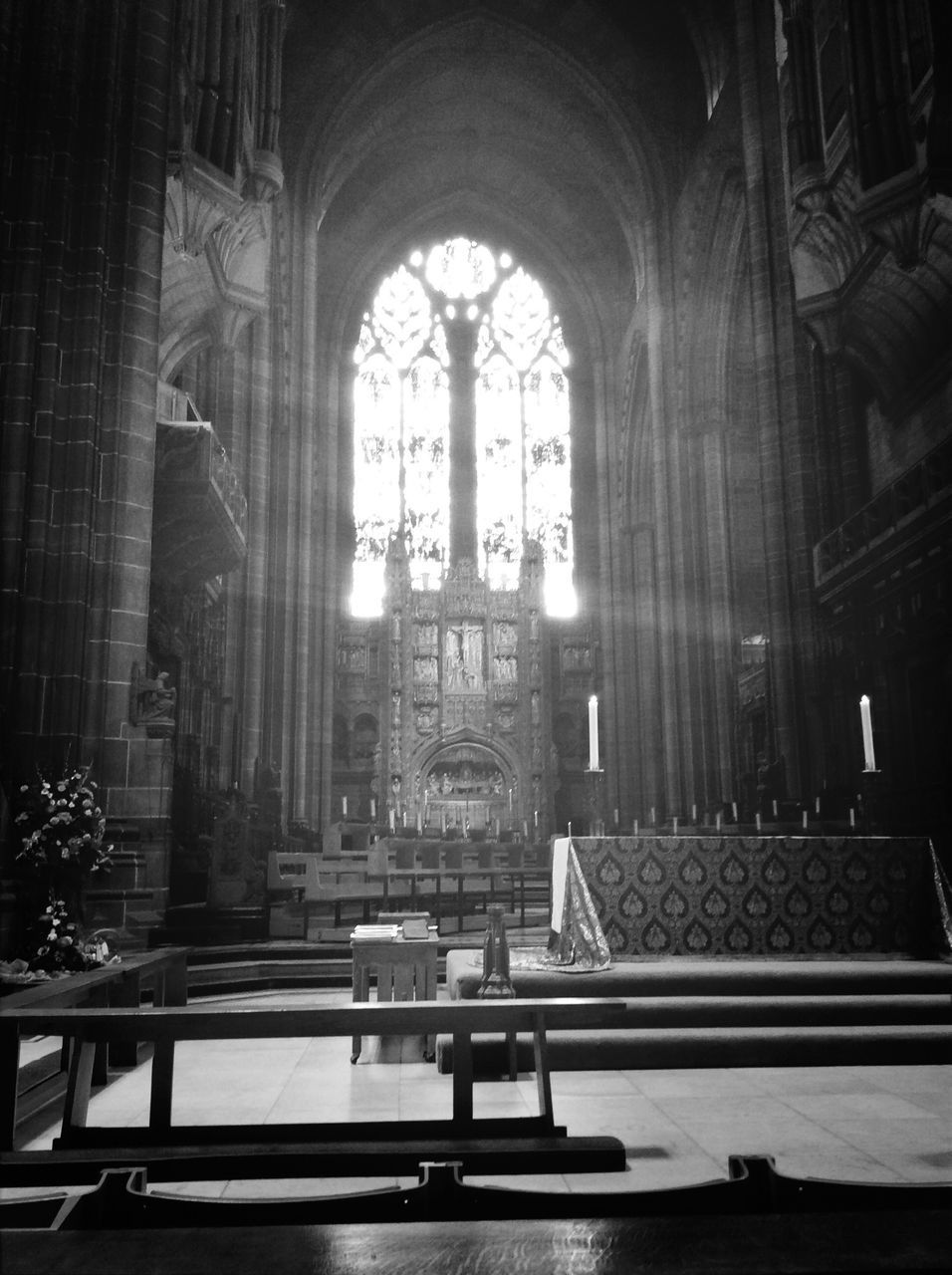 indoors, place of worship, religion, church, spirituality, architecture, built structure, arch, window, cathedral, history, low angle view, architectural column, cross, interior, sunlight, day, famous place