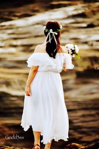 Midsection of woman standing on rock