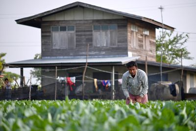 Boy standing by house