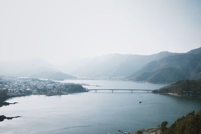 Scenic view of lake and mountains against clear sky