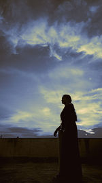 Silhouette man standing against sky during sunset