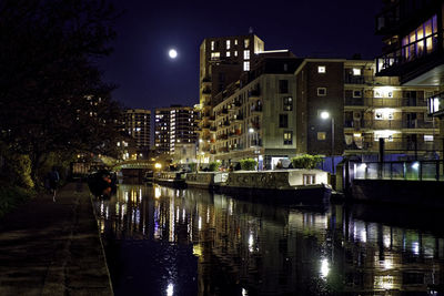 Illuminated buildings in water at night