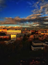 High angle view of illuminated buildings in town against sky