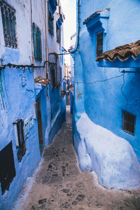 Street amidst houses in city during winter