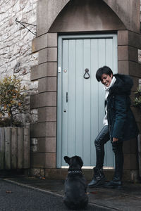 Full length of woman with dog