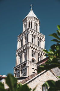 Low angle view of building against clear blue sky