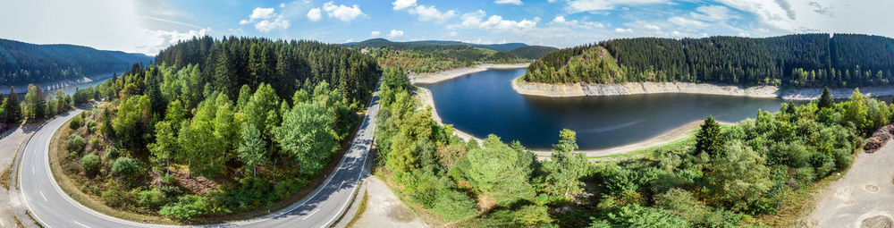 Panoramic view of lake and trees against sky