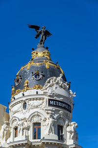 Low angle view of statue against building