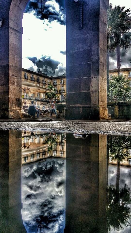 reflection, architecture, built structure, building exterior, water, waterfront, architectural column, sky, town, historic, monument, history, standing water