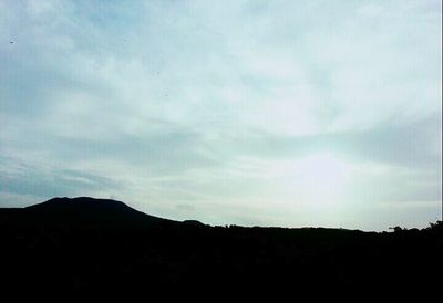 Scenic view of mountains against cloudy sky