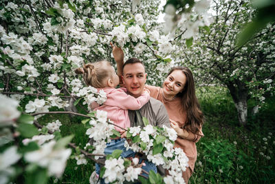 Family mom mom baby daughter in the garden blooming apple trees