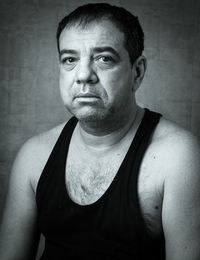 Portrait of mature man against wall