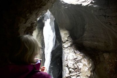 Rear view of child looking at waterfall