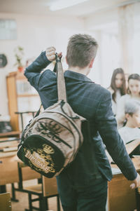 Rear view of a man with umbrella