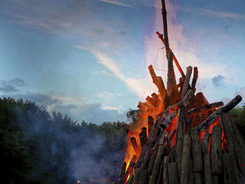 Low angle view of bonfire against sky