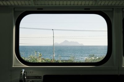 View of sea seen through train window