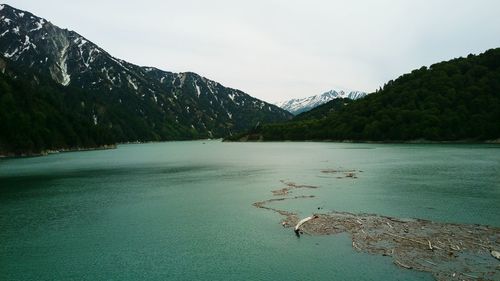 Scenic view of lake and mountains against sky