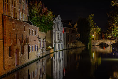 Reflection of building on lake at night