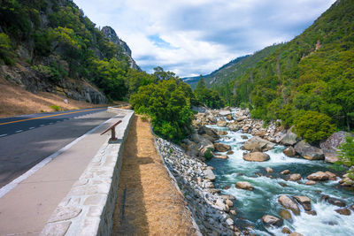 Scenic view of river amidst mountains against sky