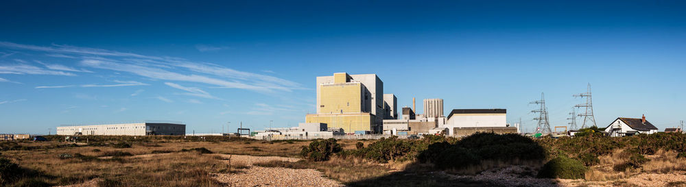 Scenic view of buildings against blue sky