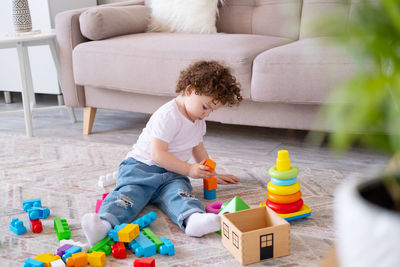 High angle view of boy playing with toys at home