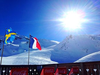 Snow covered mountain against blue sky