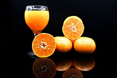 Close-up of orange fruits against black background