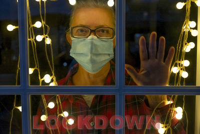 Portrait of man seen through glass window