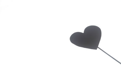 Low angle view of heart shape against white background